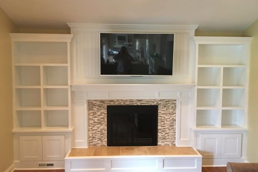 Living room built-ins and fireplace surround painted bright white